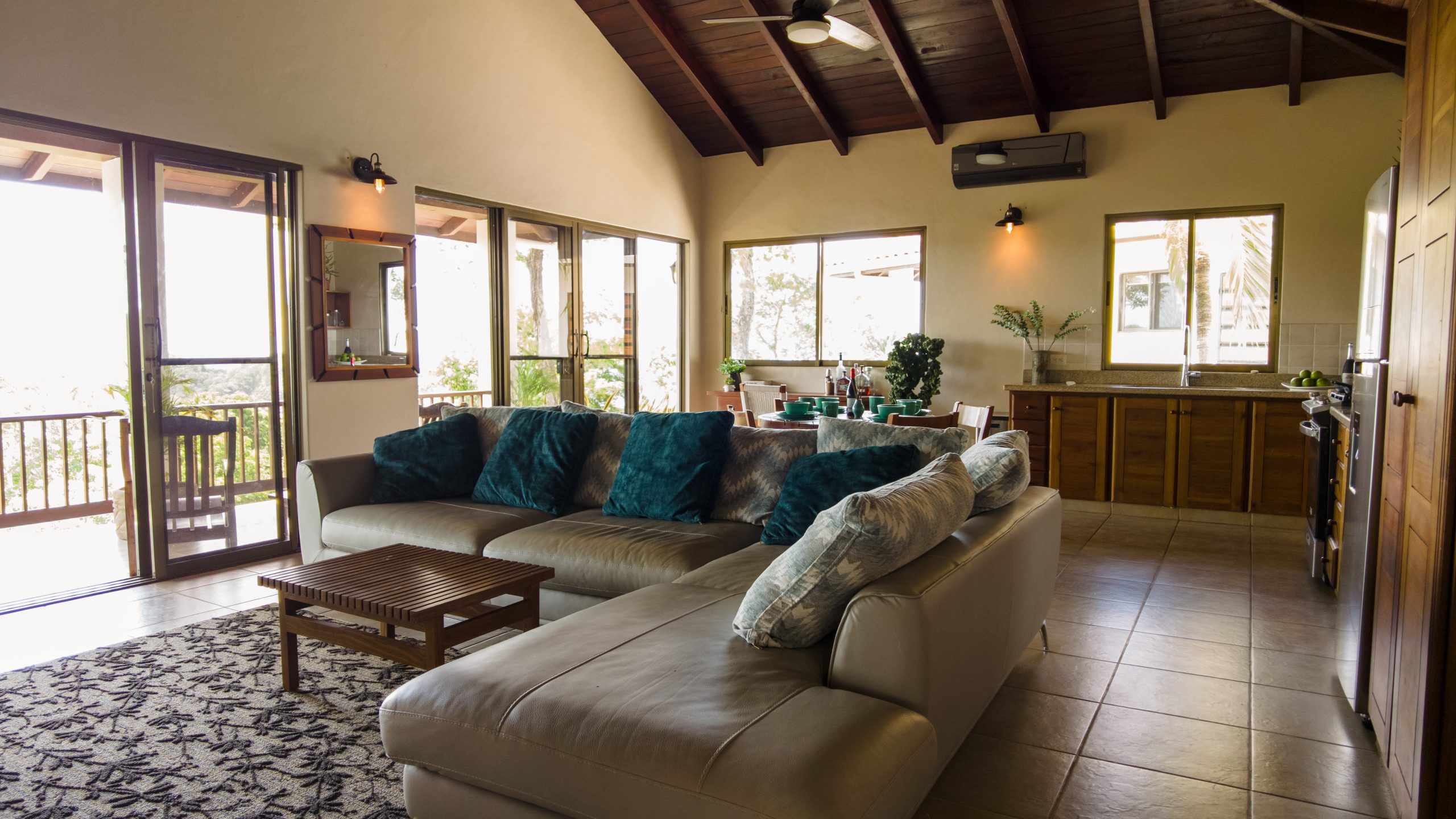 Cala Azul Crown Point Lot 3 common living area in primary structure furnished with couch looking from entertainment area towards dinning area.