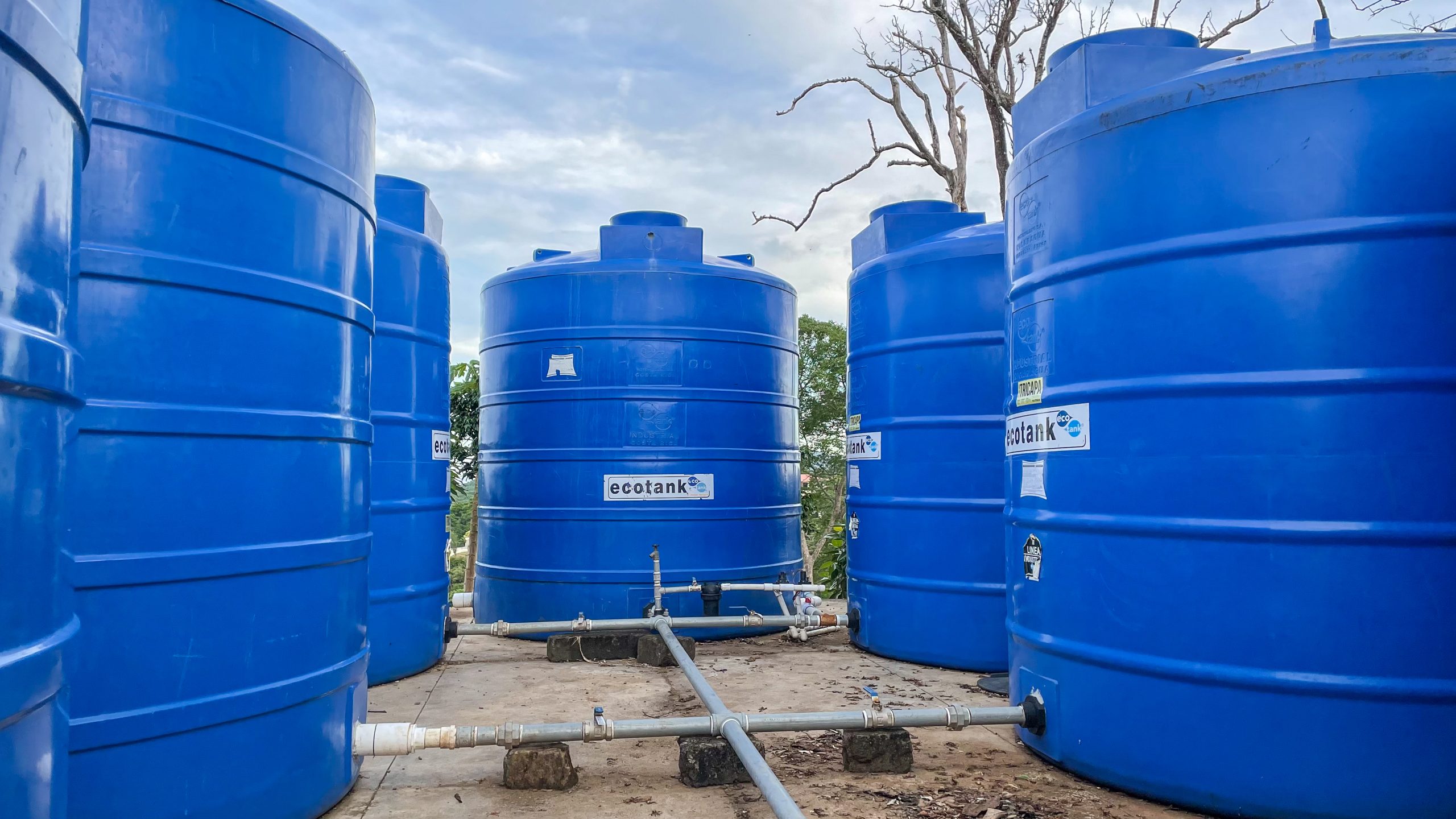Cala Azul Rainwater harvesting above ground storage tanks with piping for distribution to water landscaping