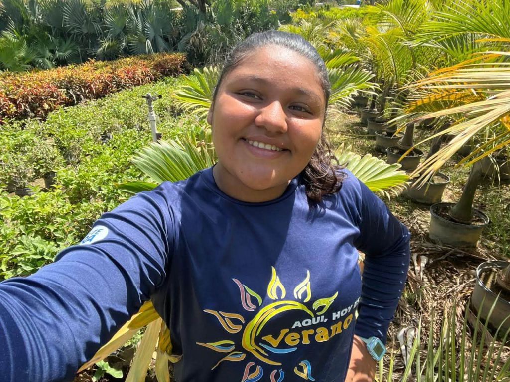 Cala Azul team member standing among lush tropical gardens